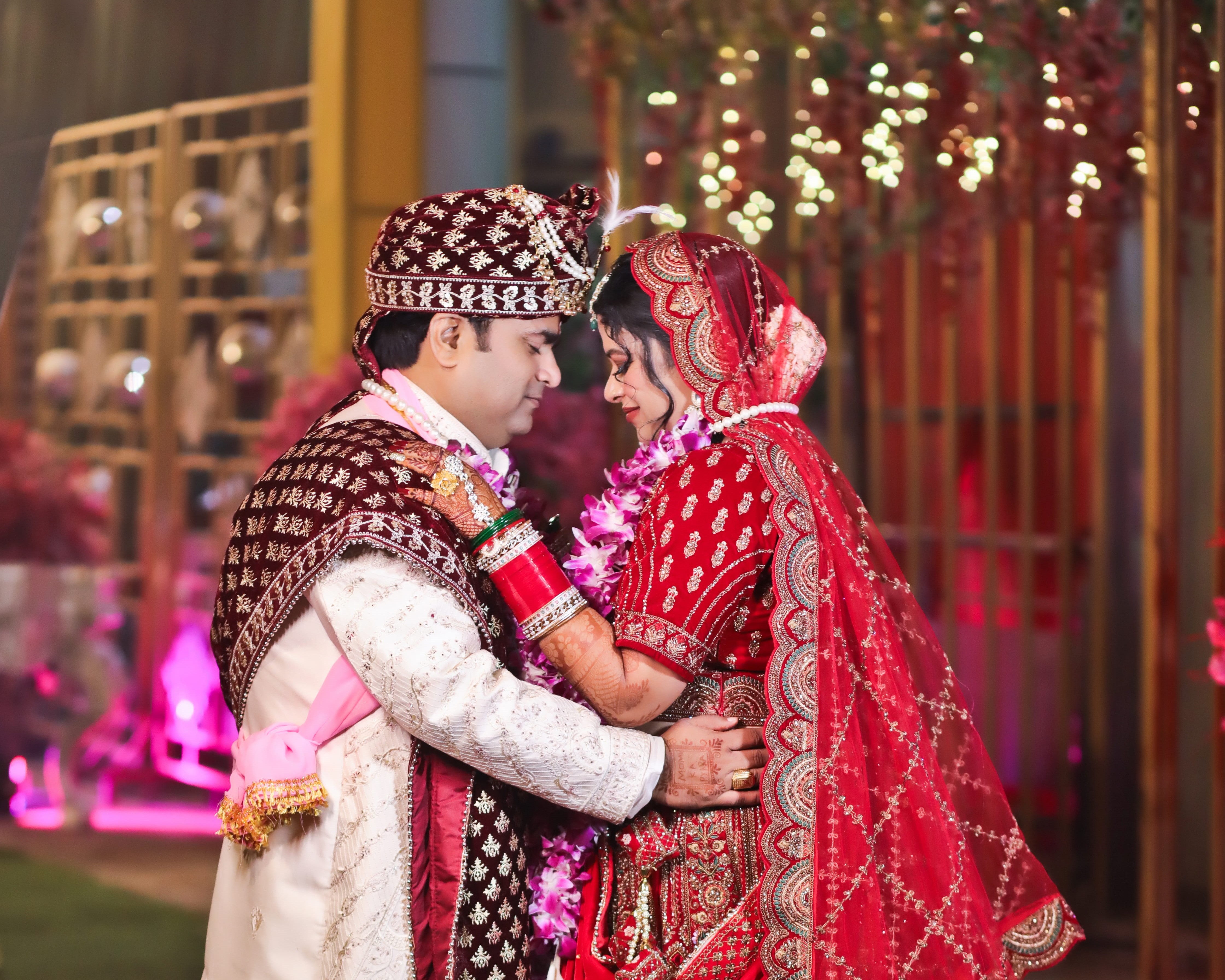 Luxury wedding couple dancing at old car in light